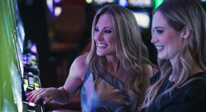 Two women playing the slots