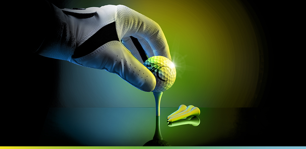 Hand putting a golf ball on a tee