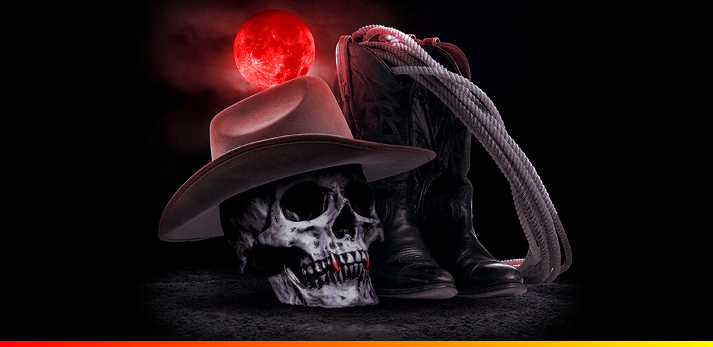 Skull wearing a cowboy sitting next to a pair of boots