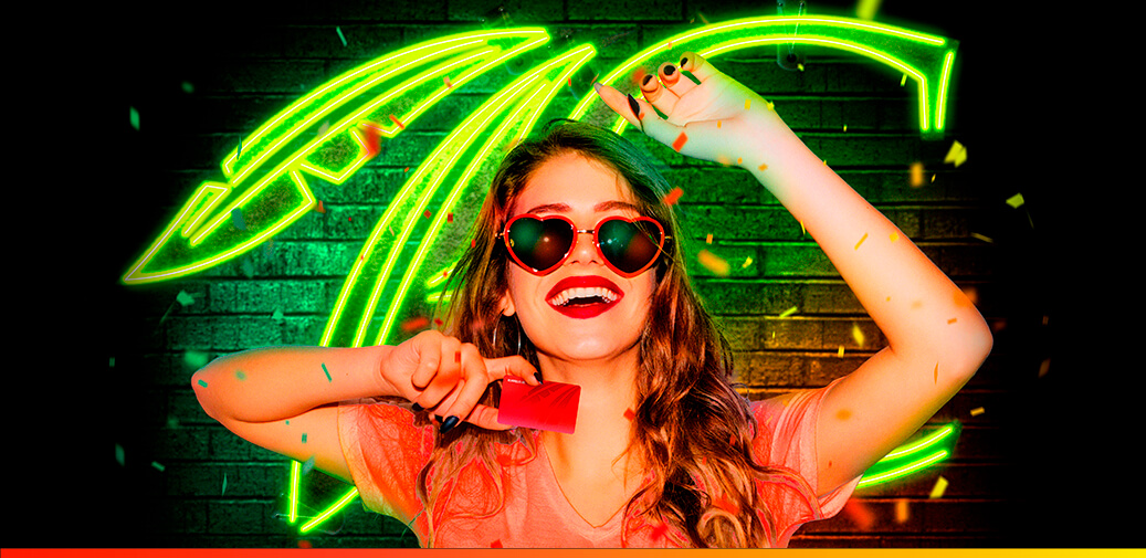 Girl holding a ruby rewards card with a neon green choctaw C behind her