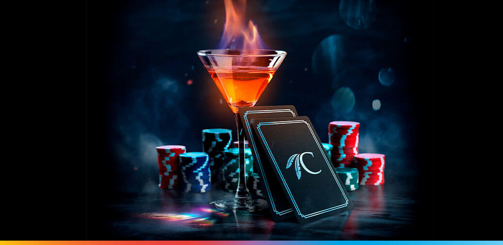 Martini on fire with playing cards and table game chips around it