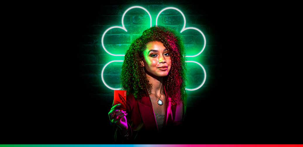 A woman in front of a four leaf clover