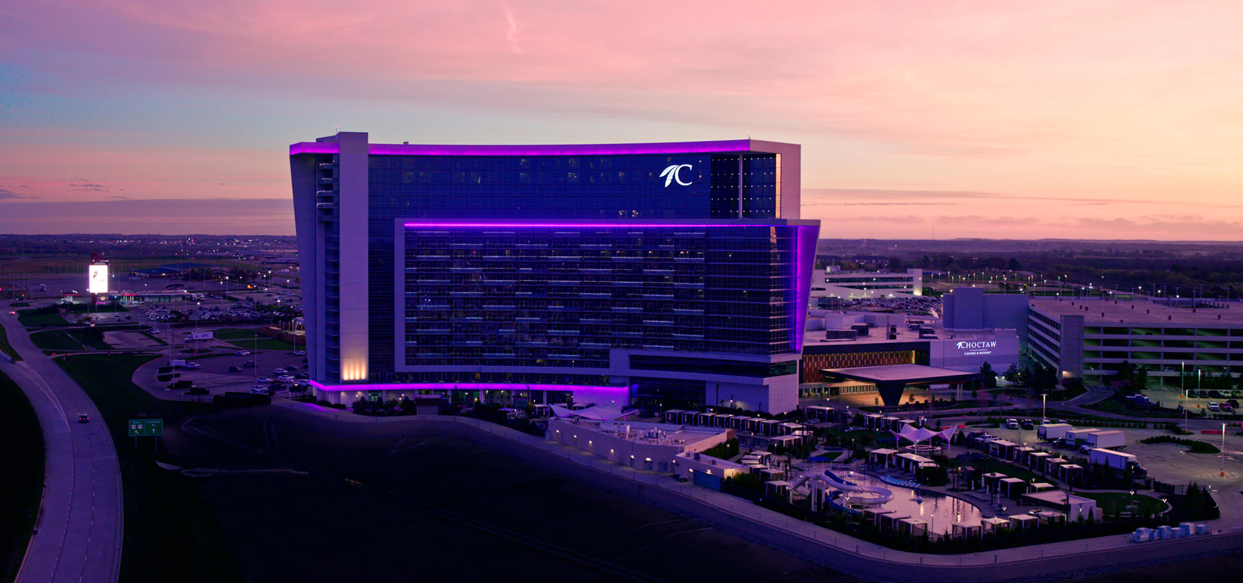 Choctaw Casino & Resort - Durant lit up purple with a sunset in the background