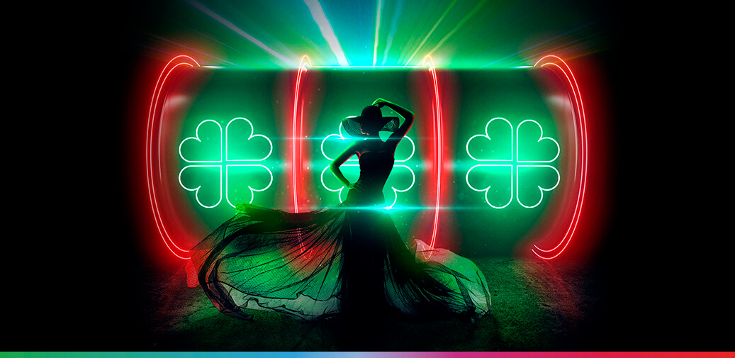 Girl dancing in front of a slot reel with four leaf clovers on it