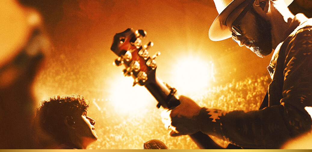 A photo of a man holding a guitar