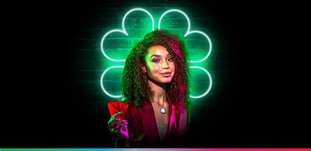 L.E.D 4 leaf clover with a girl in front of it