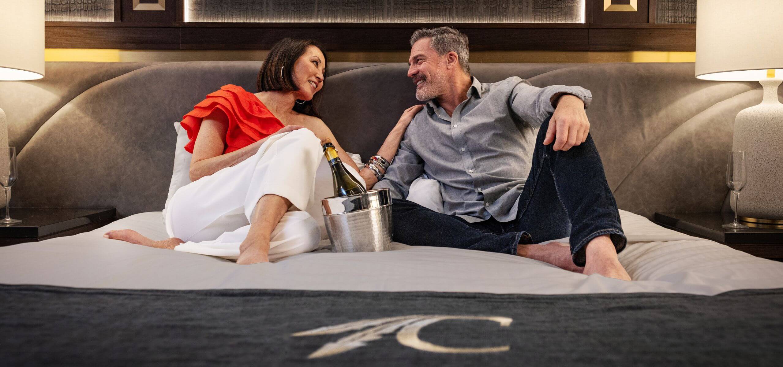 A couple lounging on a bed