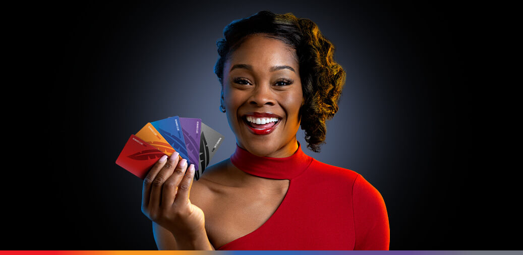 A woman holding Rewards Cards