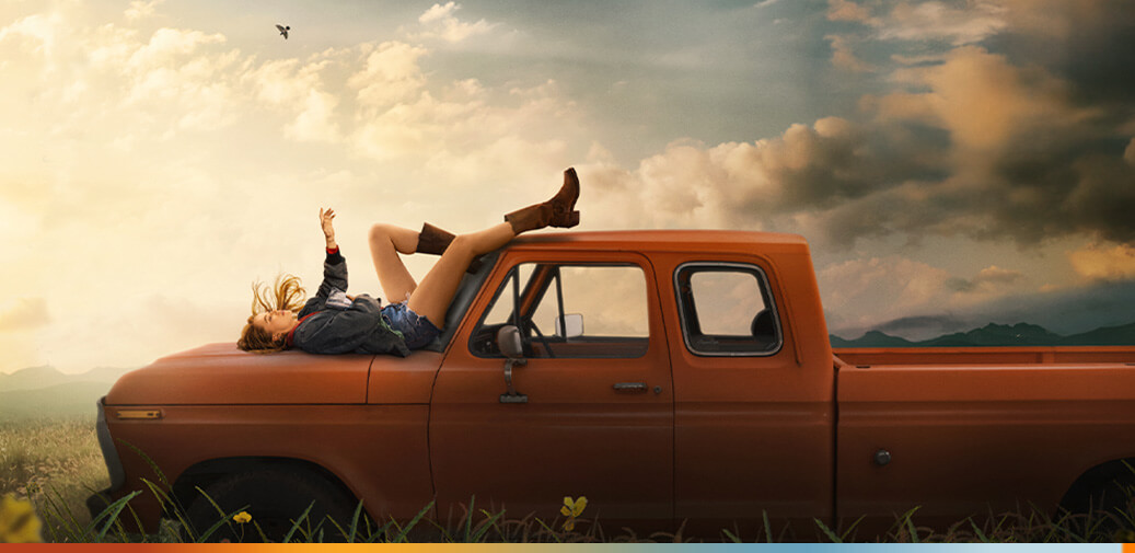Girl laying on truck hood