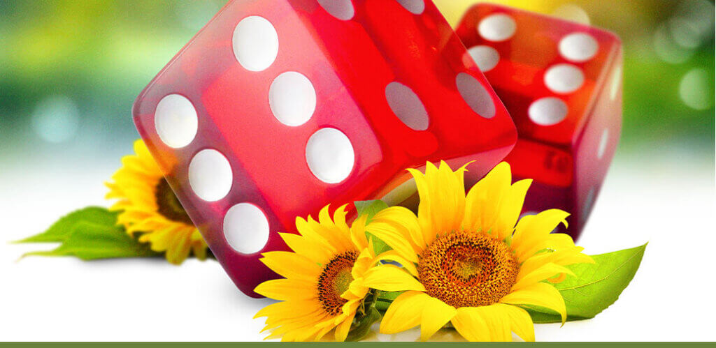 Red dice surrounded by sunflowers