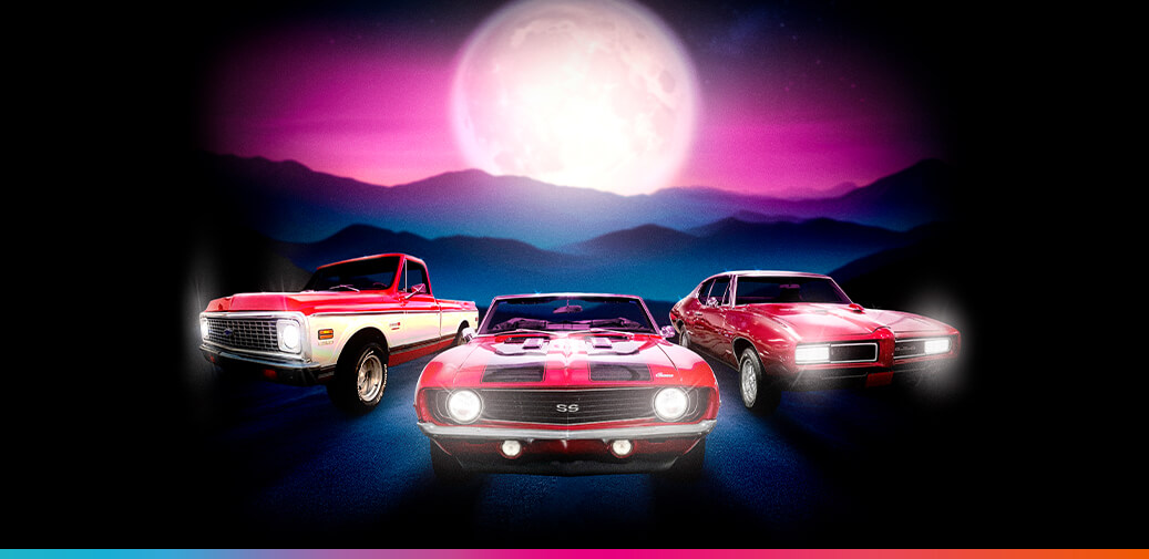 Classic cars beneath a full moon.