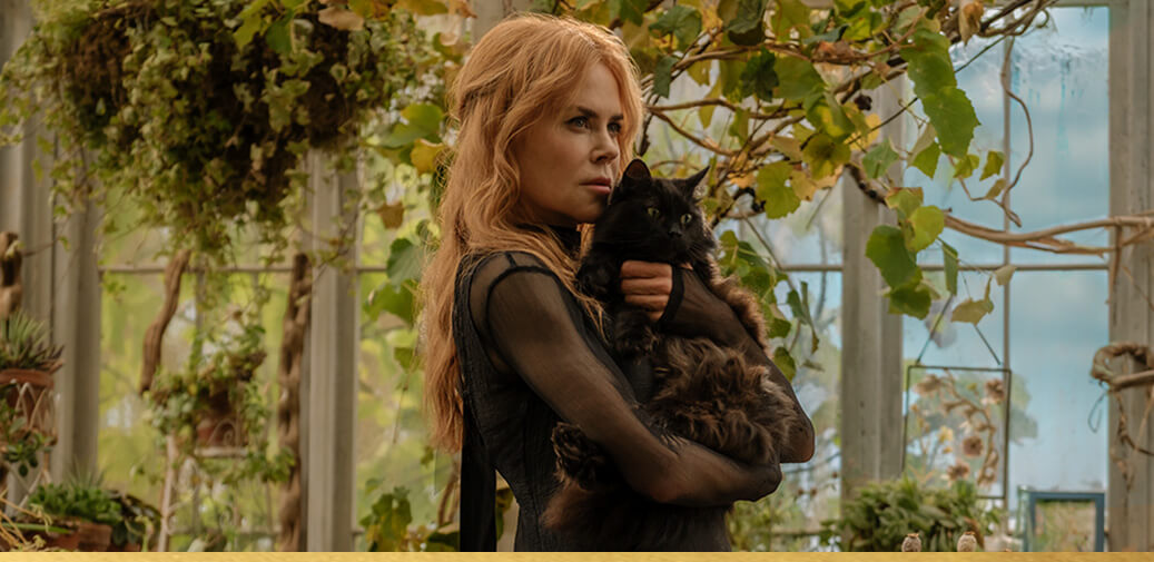 Woman holding a black cat