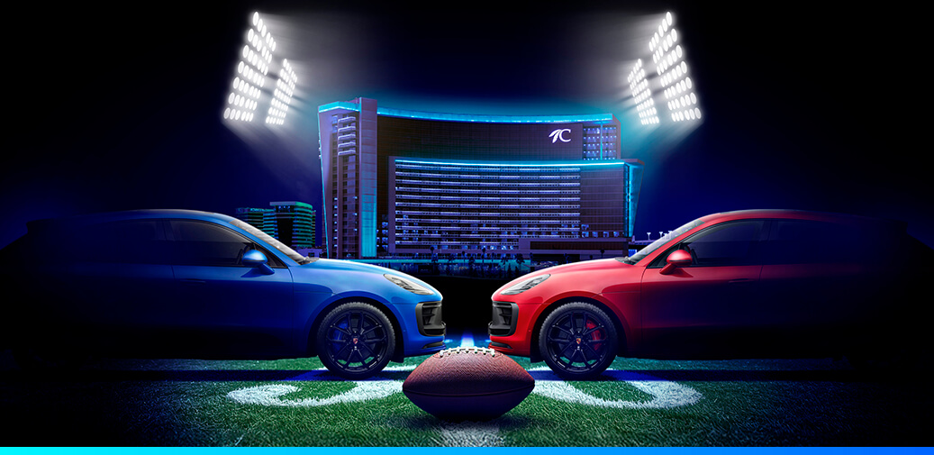 Two cars facing each other with a football in front of Choctaw Casino & Resort–Durant.