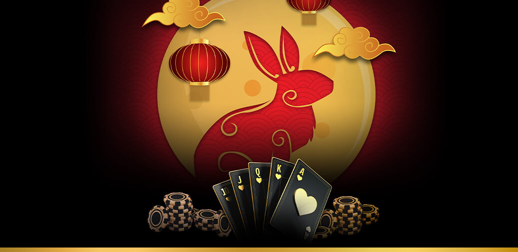 A red bunny with black playing cards in front of it